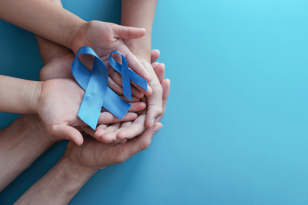 2 people's hands holding prostate cancer awareness ribbons. genetic risk concept